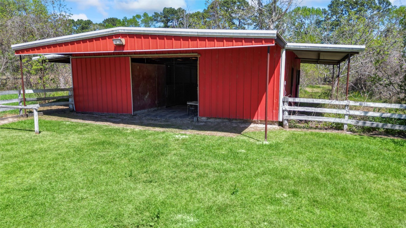 187 Watson Lake Road Huntsville, TX 77340 - Photo 3 of 25 a view of a house with a backyard