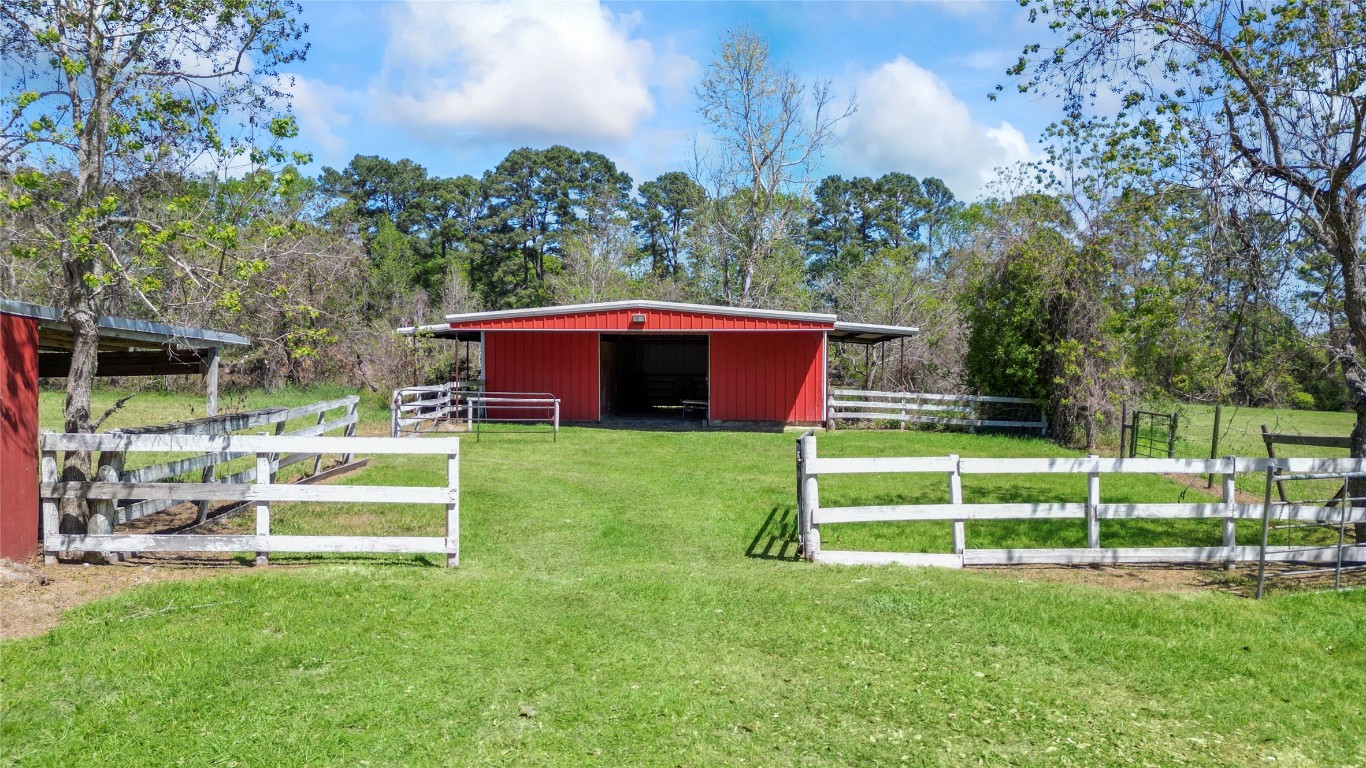 187 Watson Lake Road Huntsville, TX 77340 - Photo 6 of 25 a front view of a house with a yard table and chairs