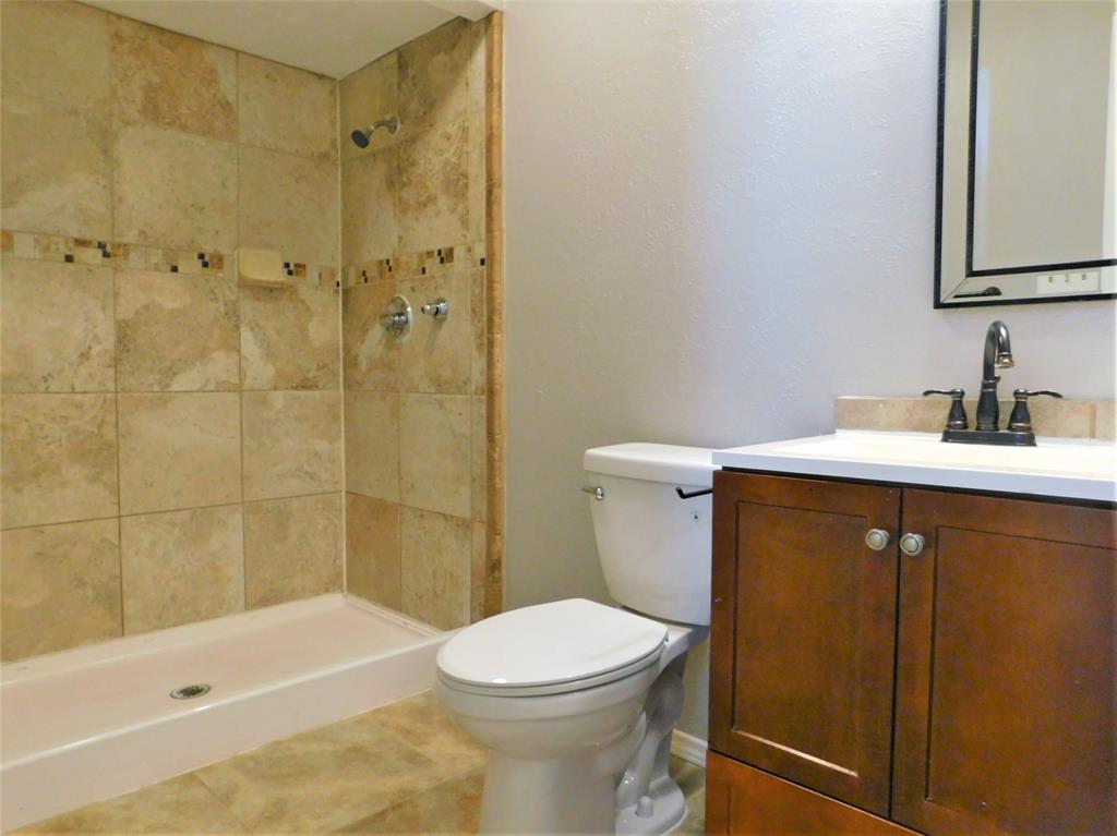 421 Shadowcrest Lane Coppell, TX 75019 - Photo 12 of 22 a bathroom with a sink a toilet and shower
