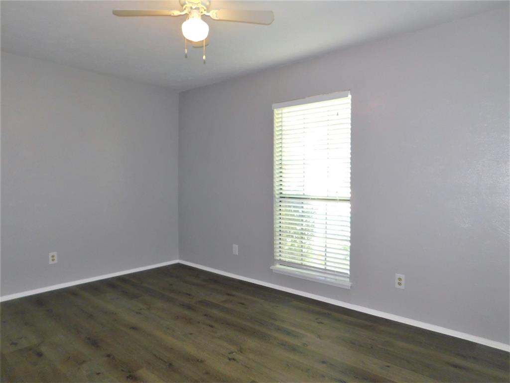 421 Shadowcrest Lane Coppell, TX 75019 - Photo 15 of 22 an empty room with wooden floor and windows