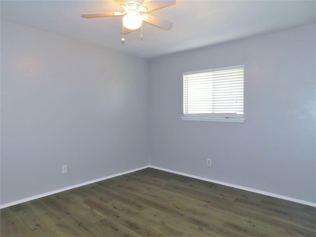 421 Shadowcrest Lane Coppell, TX 75019 - Photo 17 of 22 an empty room with wooden floor and windows