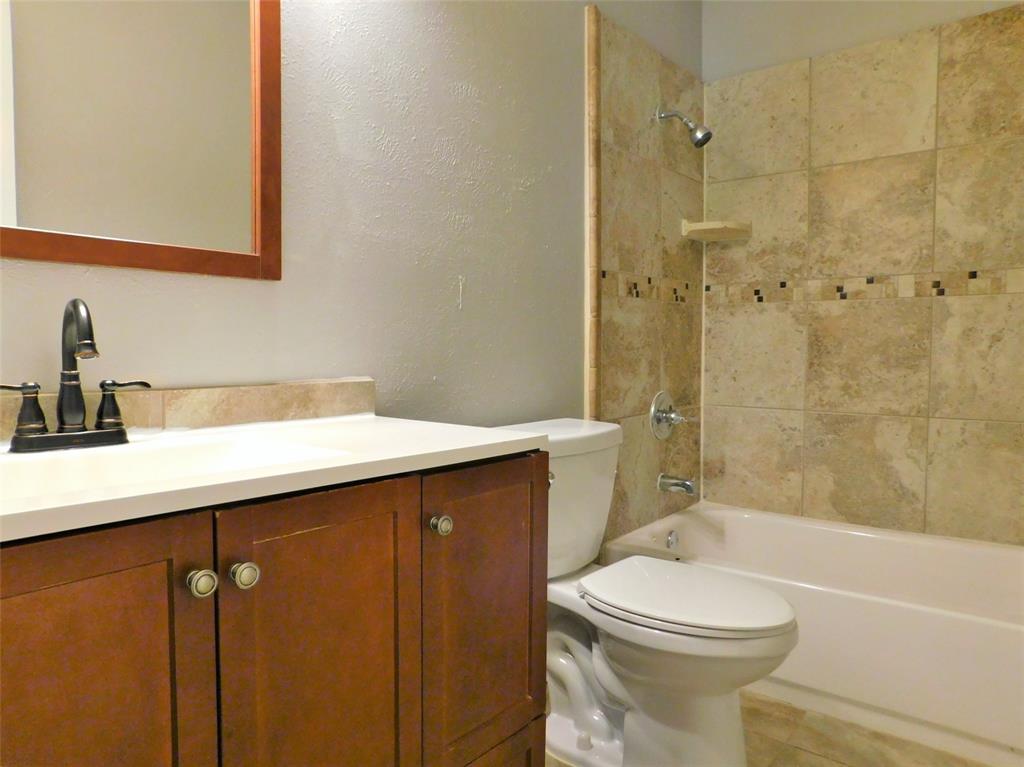 421 Shadowcrest Lane Coppell, TX 75019 - Photo 18 of 22 a bathroom with a sink a toilet and shower