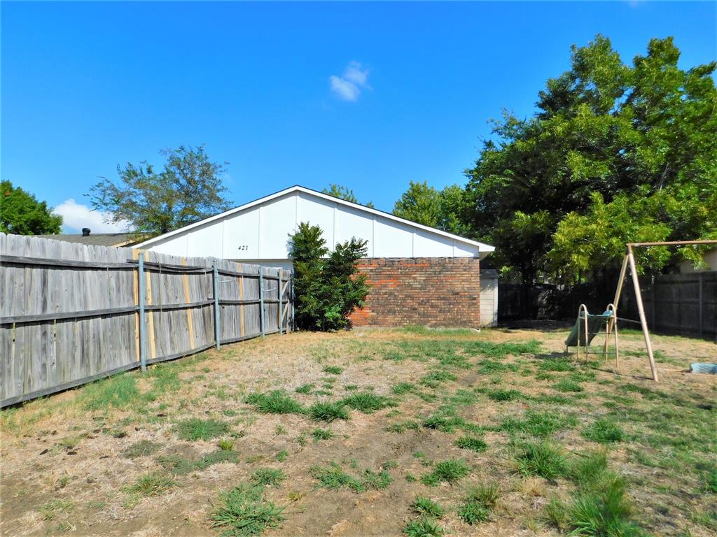 421 Shadowcrest Lane Coppell, TX 75019 - Photo 22 of 22 a backyard of a house with plants and large tree