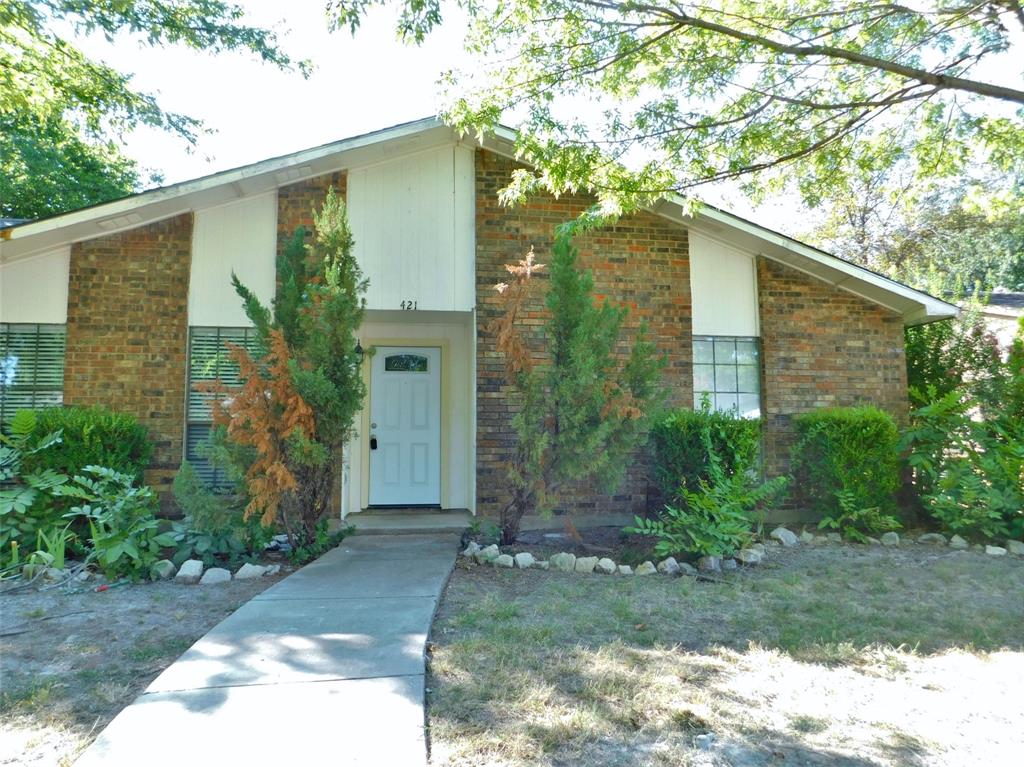 421 Shadowcrest Lane Coppell, TX 75019 - Photo 3 of 22 a front view of a house with garden