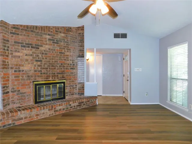 a view of empty room with window and fireplace