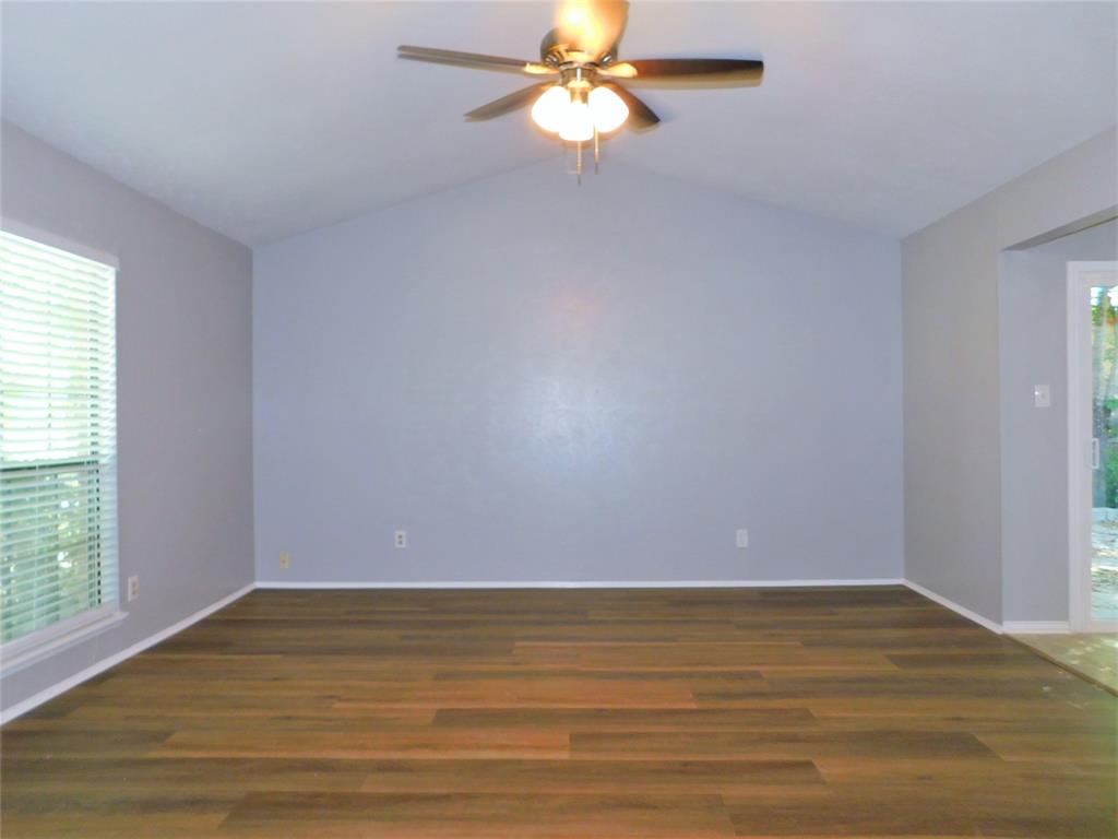 421 Shadowcrest Lane Coppell, TX 75019 - Photo 6 of 22 a view of a room with a ceiling fan and wooden floor