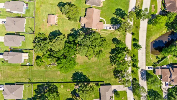 an aerial view of residential houses with yard