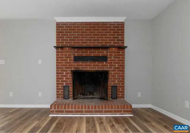 a view of fireplace and wooden floor