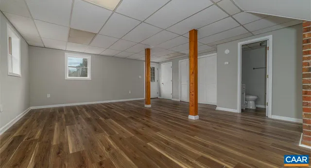 a view of a room with wooden floor and window