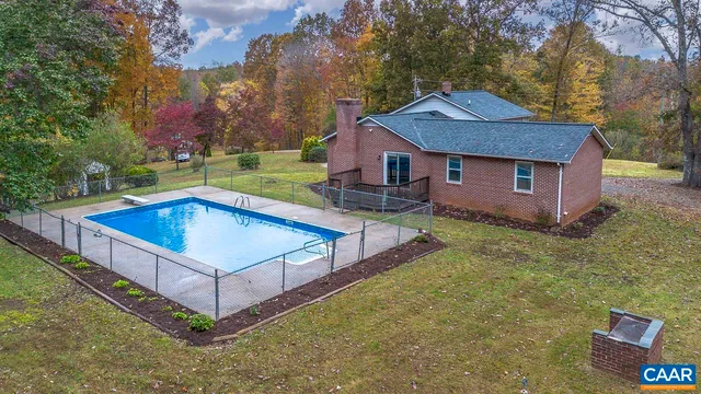 a view of a house with a yard balcony and wooden fence