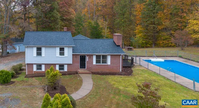 a aerial view of a house with swimming pool and sitting area