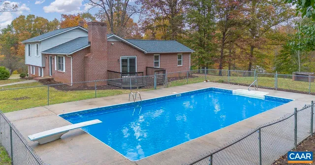 a view of an house with swimming pool and sitting area