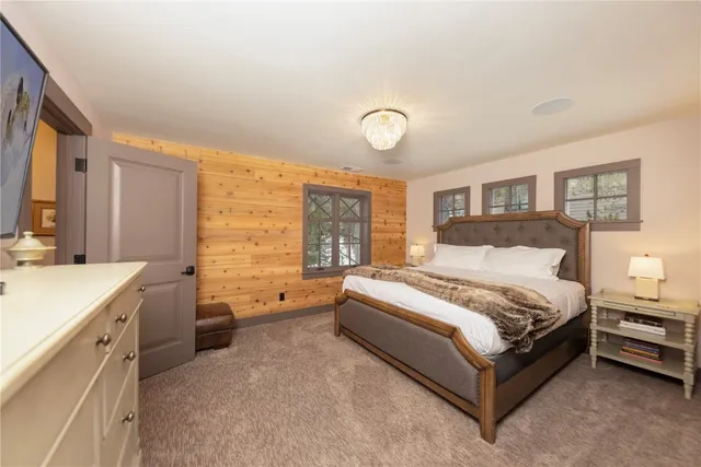 a spacious bedroom with a bed and a large window