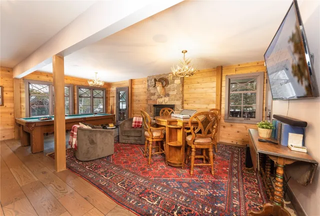 a dining room with furniture a rug and wooden floor