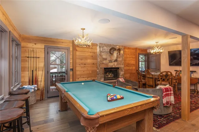 a room with pool table and windows