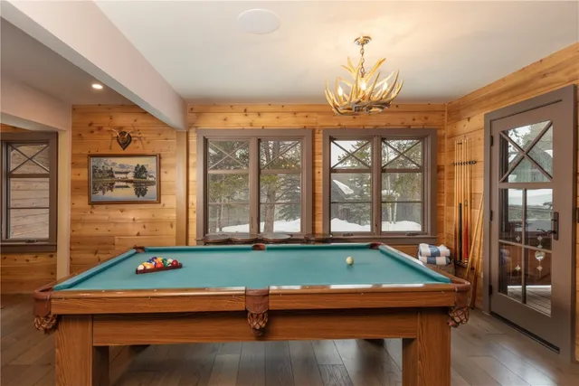 a room with pool table and windows
