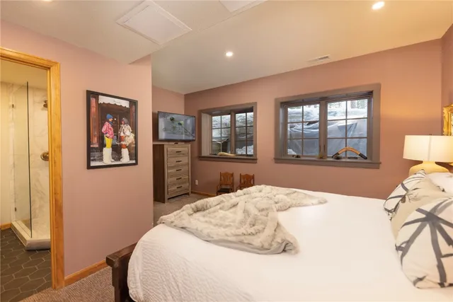 a bedroom with a large bed and a window