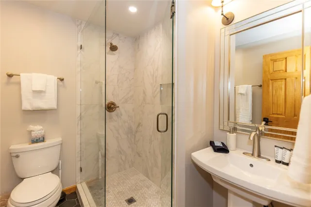 a bathroom with a sink toilet and shower