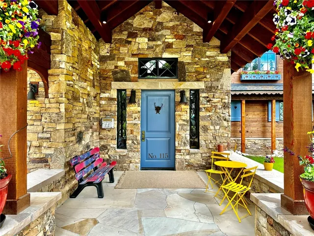 a building outdoor space with patio furniture and potted plants