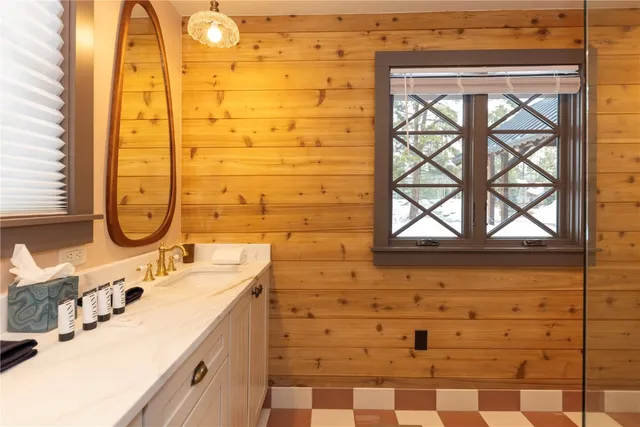 a bathroom with a sink a mirror and a shower