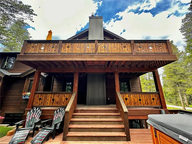 a view of a house with pool and chairs