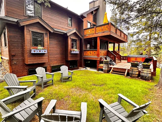a view of a chairs and table on the wooden deck