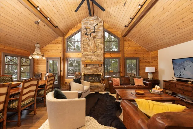 a living room with lots of furniture and a floor to ceiling window