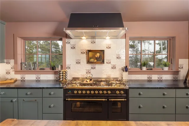 a kitchen with granite countertop a stove and a sink