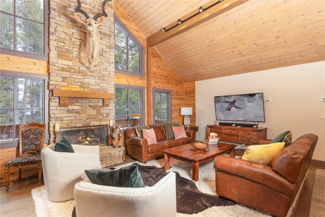 a living room with furniture and a floor to ceiling window