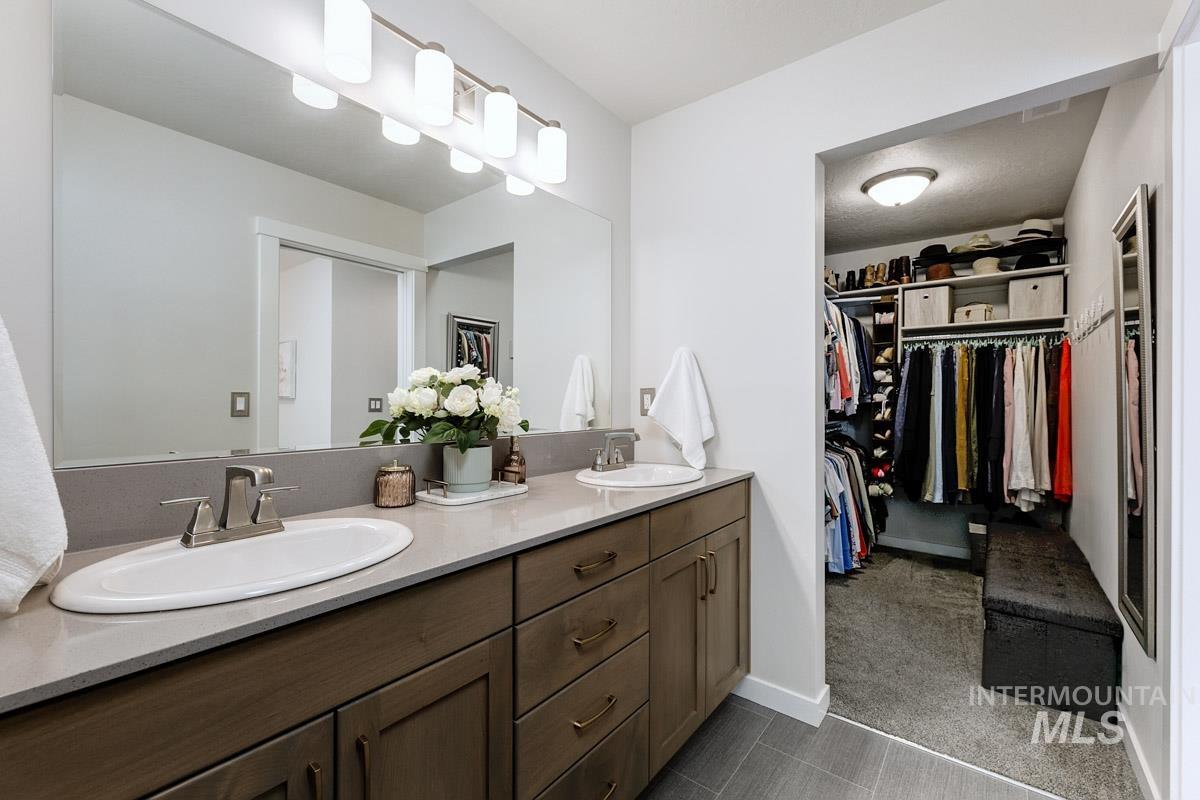 348 West Radiant Rdg Drive Meridian, ID 83642 - Photo 18 of 36 Dual vanity with undermount sinks, brushed nickel faucets, and a light-toned countertop