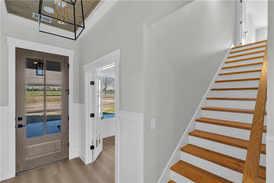 516 Lakeside Drive Anderson, SC 29621 - Photo 10 of 32 A welcoming entryway with a staircase to the upper level and a sun-drenched view of the outdoors.