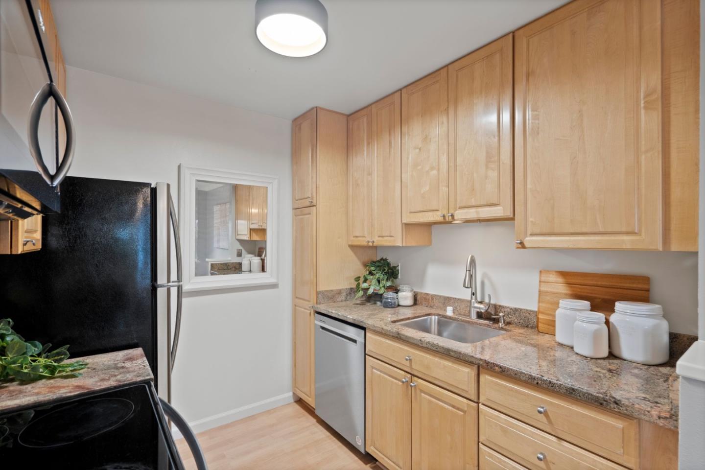 905 West Middlefield Road, Unit 923 Mountain View, CA 94043 - Photo 12 of 38 a kitchen with granite countertop stainless steel appliances a refrigerator sink and stove