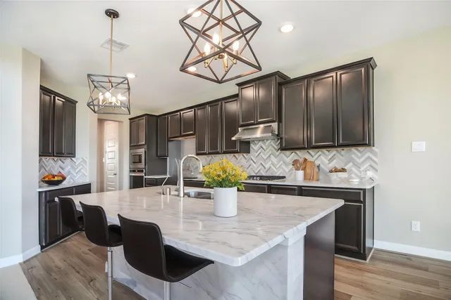 a kitchen with a table and chairs