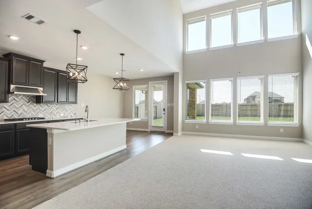 a large white kitchen with a large window
