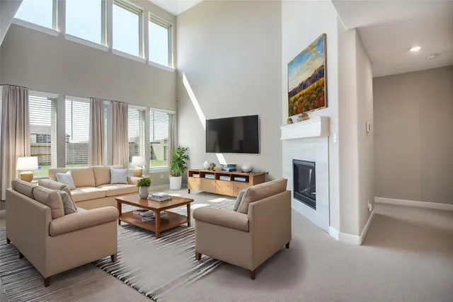 a living room with furniture a flat screen tv and a fireplace