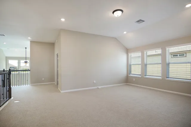 an empty room with windows and pillars in it