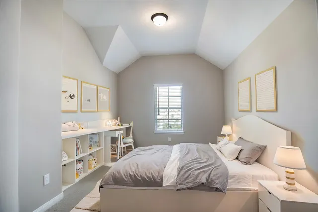 a bedroom with a large bed and a window
