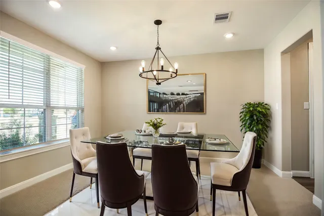 a dining room with furniture and window