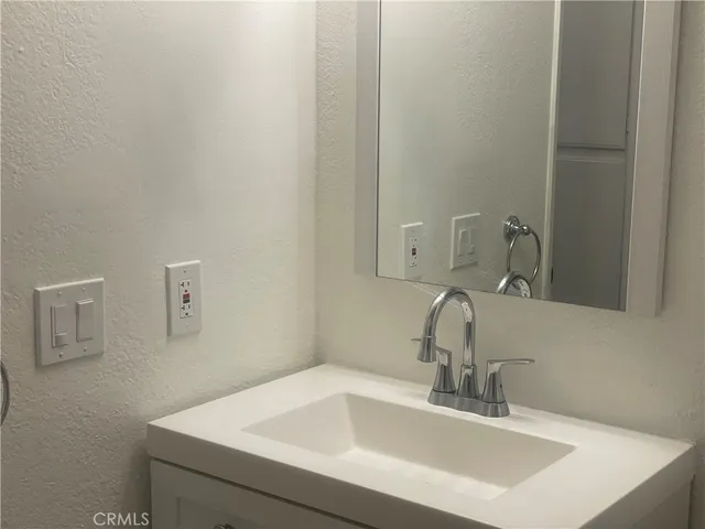 a view of a small space with wooden floor and a window