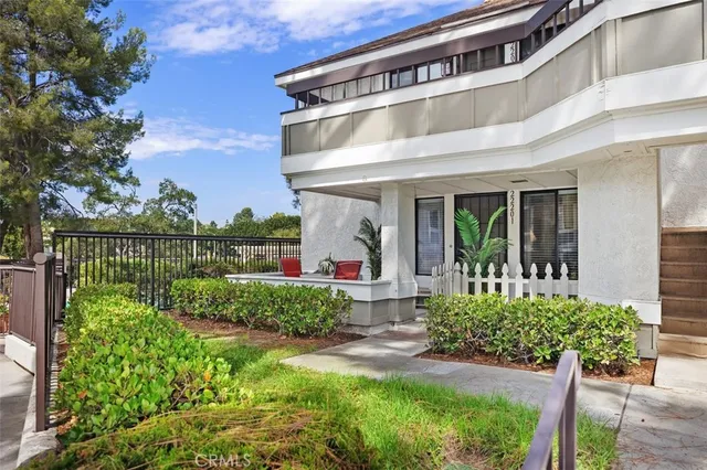 a front view of a house with a flower garden