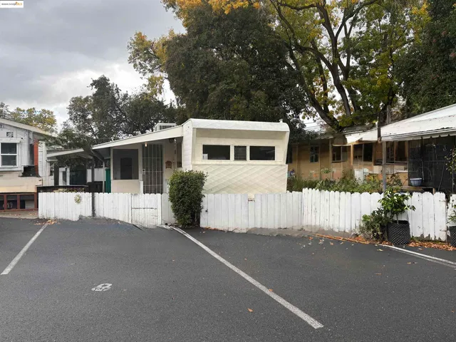 a view of a house with a backyard and a patio