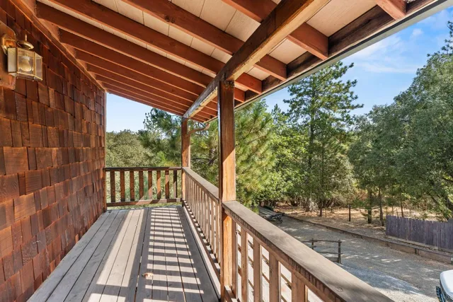 a view of balcony with wooden floor and fence