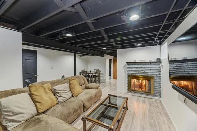 a living room with furniture and a fireplace