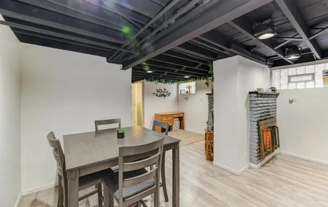a dining room with furniture a rug and a kitchen