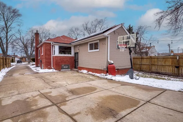a view of a house with wooden fence