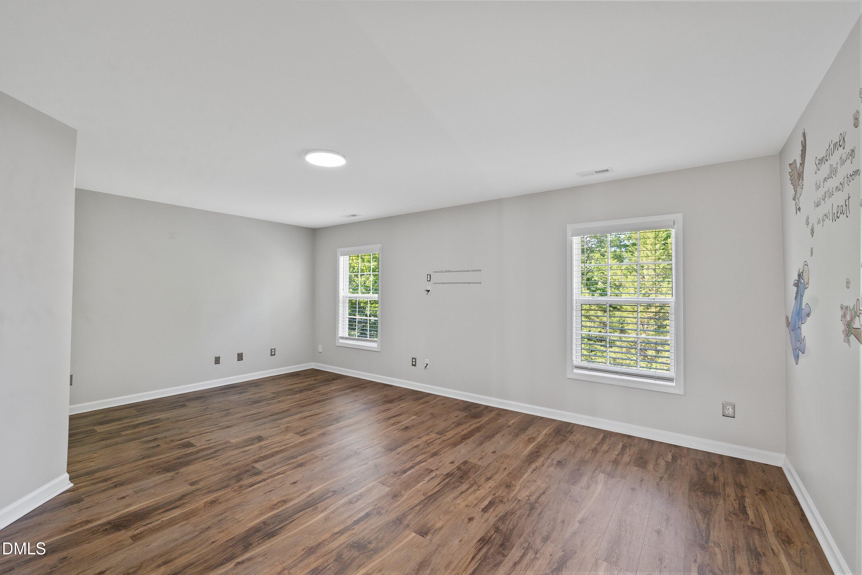 3717 Windmeade Road Wake Forest, NC 27587 - Photo 38 of 51 an empty room with wooden floor and windows