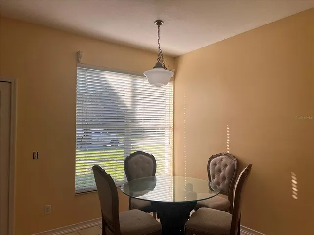 a dining room with furniture and window