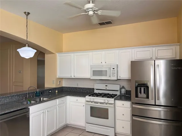 a kitchen with a sink a stove and refrigerator