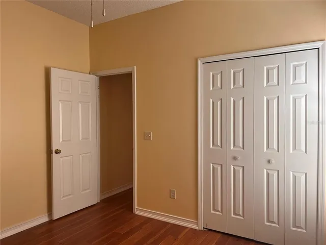 an empty room with wooden floor