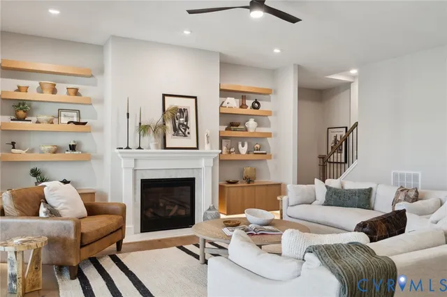 a living room with furniture and a fireplace